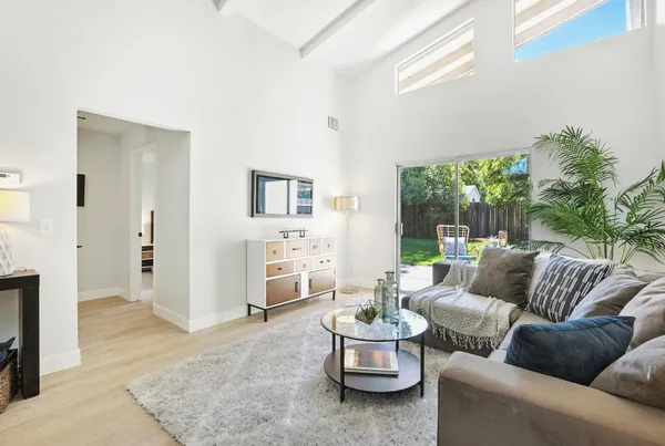 a living room with furniture and painting on the wall