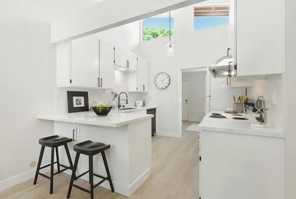 a kitchen with a sink cabinets and wooden floor