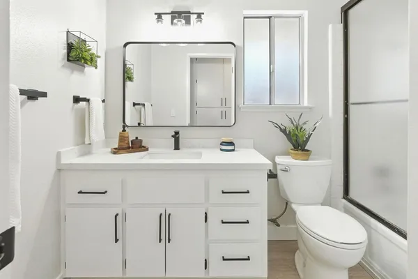 a bathroom with a shower curtain a mirror and a sink