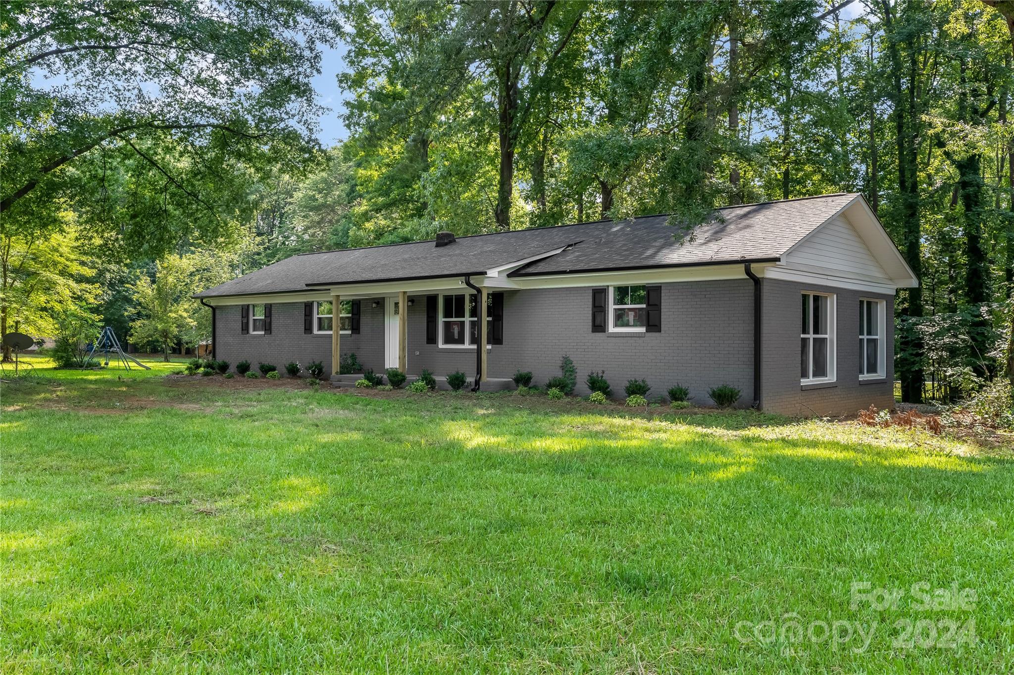 13320 Old Camden Road Midland, NC 28107 - Photo 1 of 22 a aerial view of a house with a yard table and chairs