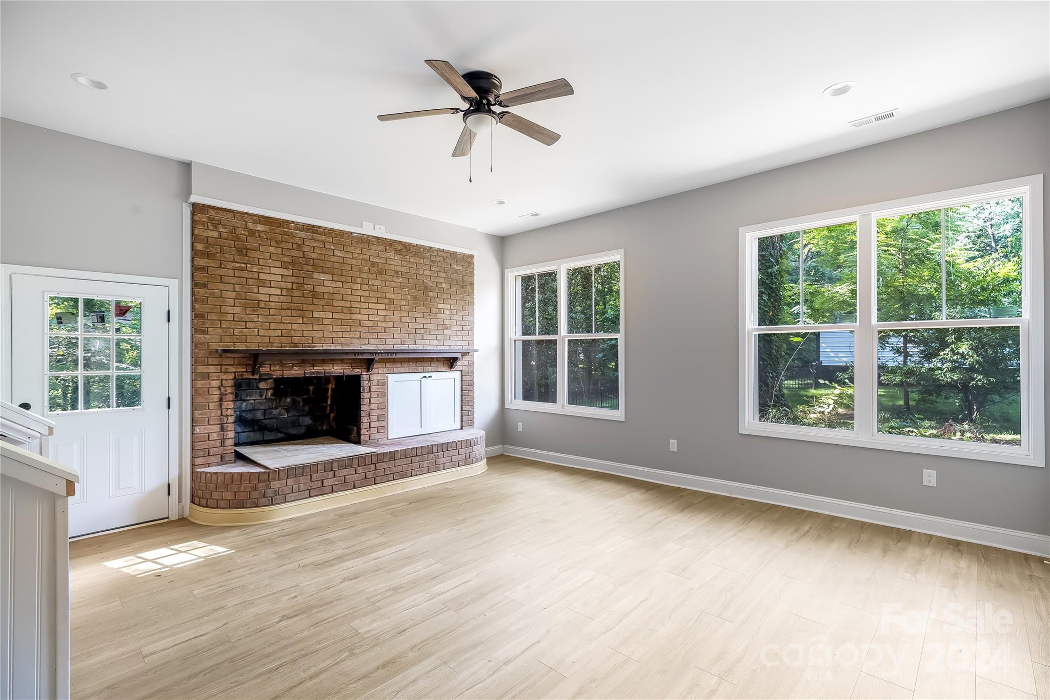 13320 Old Camden Road Midland, NC 28107 - Photo 4 of 22 a view of an empty room with a fireplace and a window