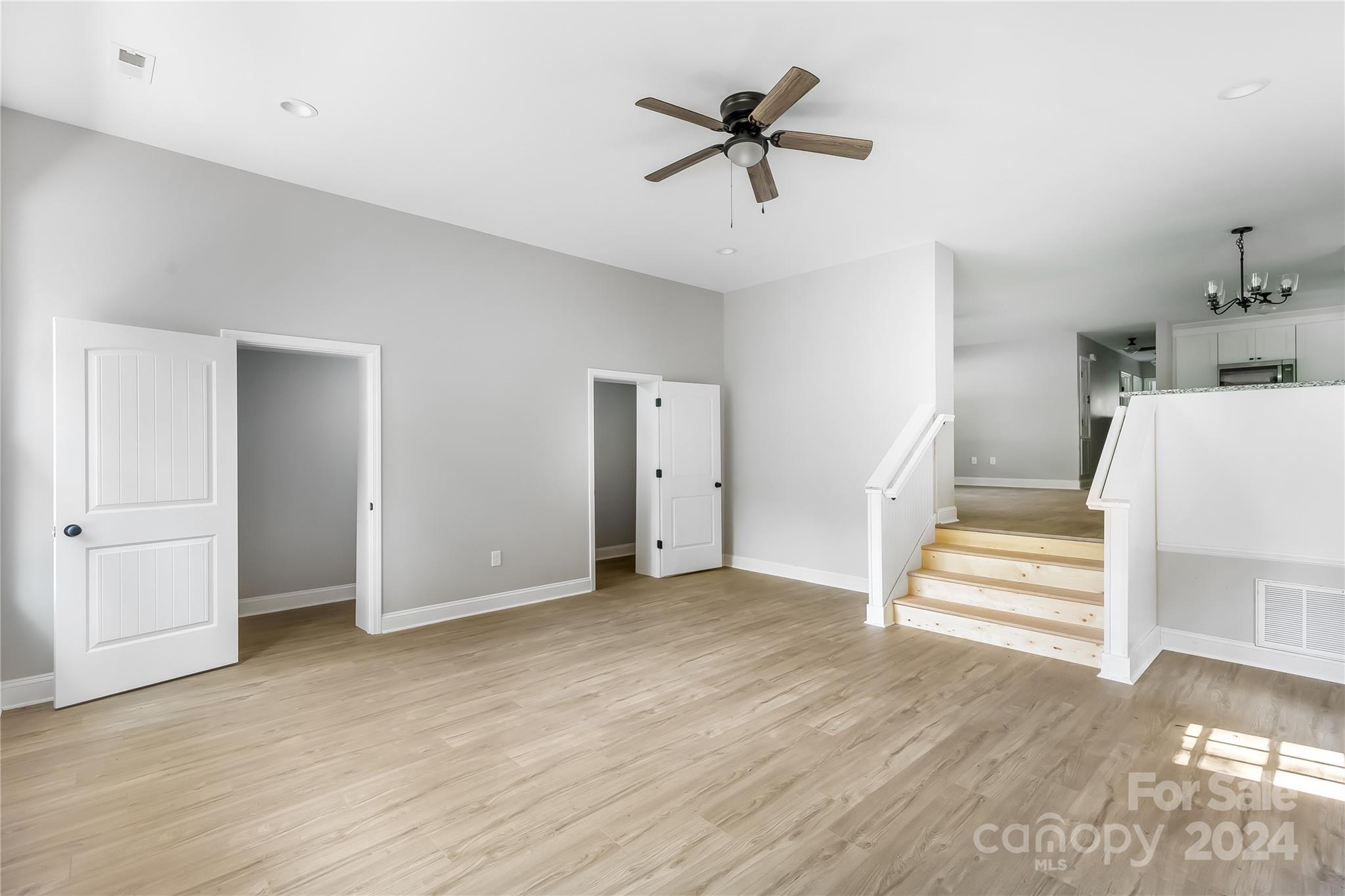 13320 Old Camden Road Midland, NC 28107 - Photo 5 of 22 a view of an empty room with wooden floor and a ceiling fan