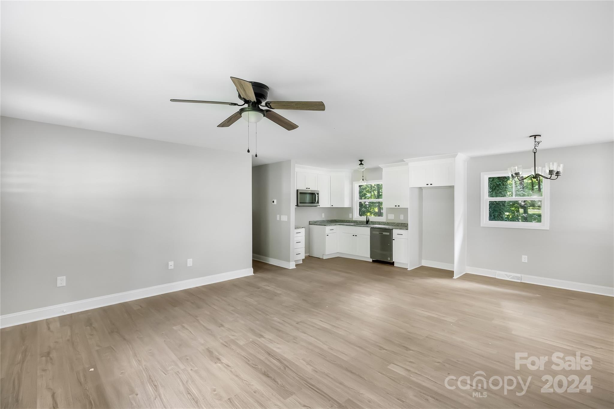13320 Old Camden Road Midland, NC 28107 - Photo 8 of 22 a view of a kitchen with wooden floor and a ceiling fan
