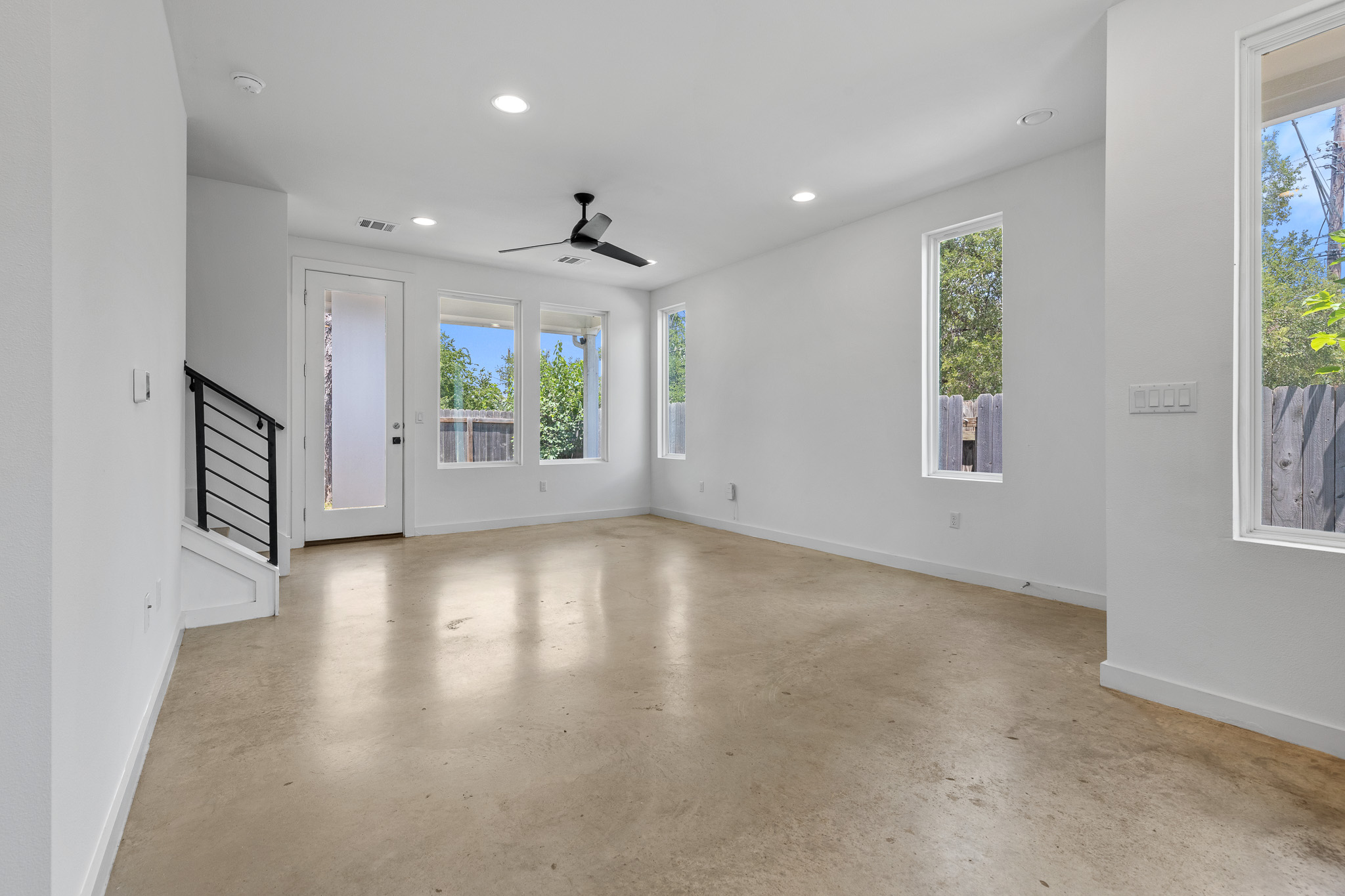 2604 Wheless Lane, Unit 1 Austin, TX 78723 - Photo 7 of 38 Large windows flood the area with natural light and tree-line views.
