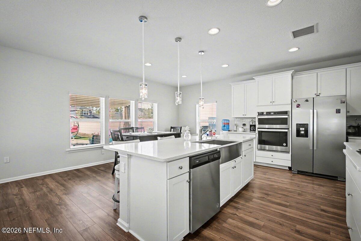55 Seton Court St. Augustine, FL 32092 - Photo 6 of 20 a kitchen with stainless steel appliances granite countertop a sink a stove and a refrigerator