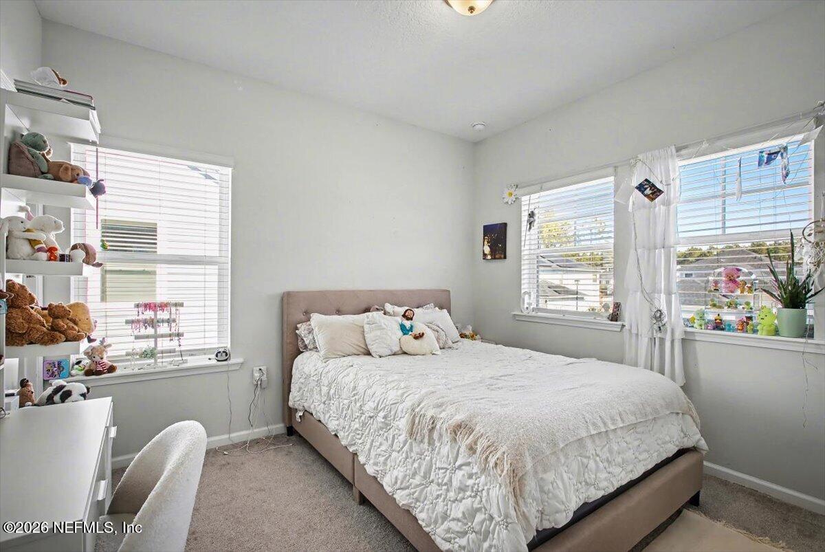 55 Seton Court St. Augustine, FL 32092 - Photo 7 of 20 a bedroom with a bed table closet and window