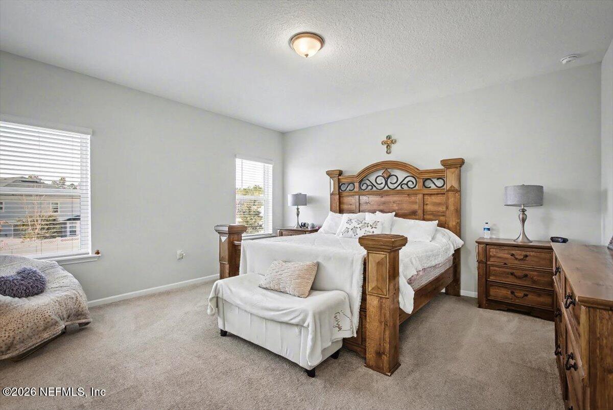 55 Seton Court St. Augustine, FL 32092 - Photo 8 of 20 a spacious bedroom with a bed and a couch