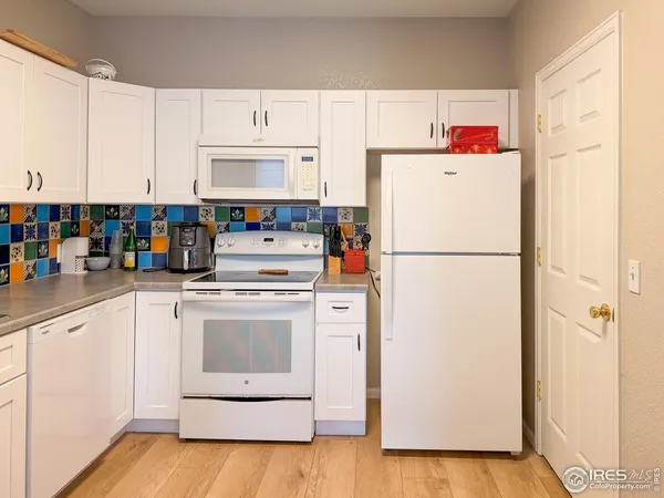 a white refrigerator freezer sitting in a kitchen