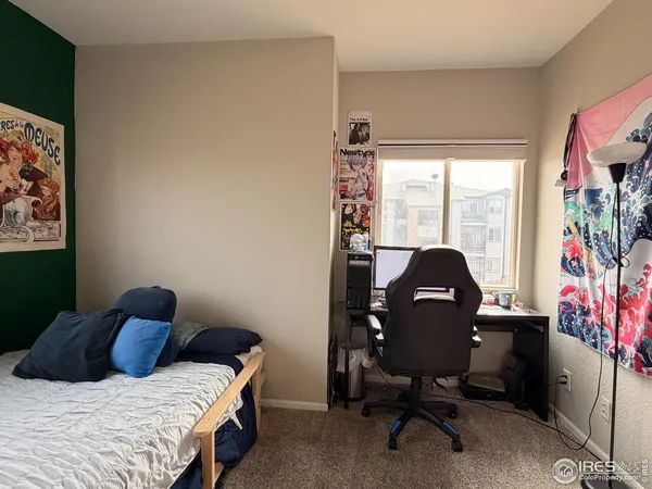 a bedroom with a bed and a bookshelf