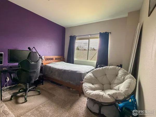 a bedroom with a bed and a chair