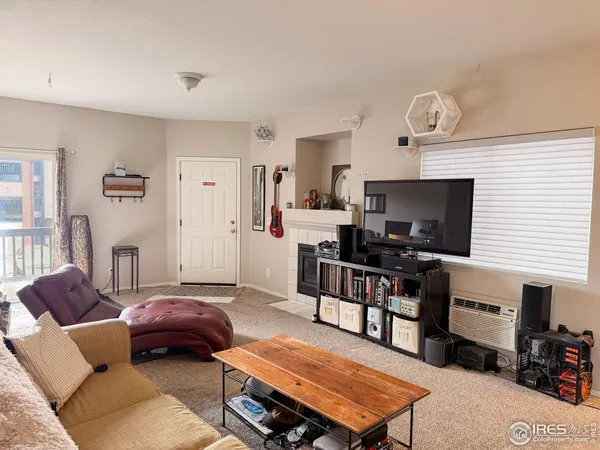 a living room with furniture and a computer on the desk