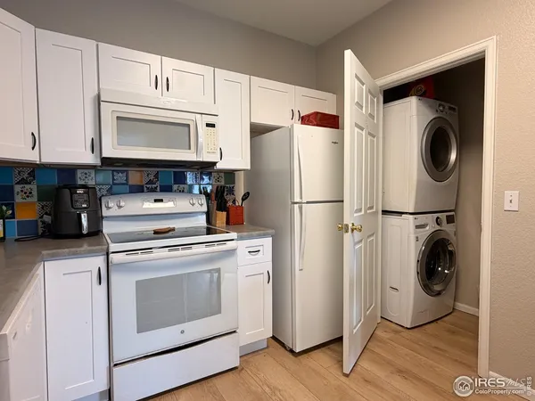 a kitchen with a stove top oven and refrigerator