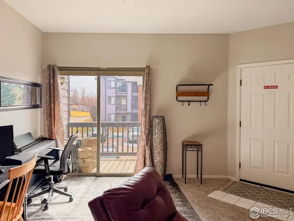 a living room with furniture a rug and a window