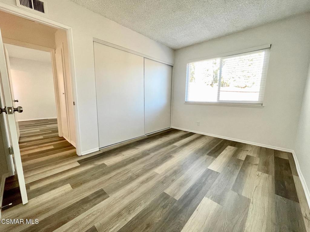 4881 Muirwood Court Simi Valley, CA 93063 - Photo 14 of 32 a view of a room with wooden floor and white walls