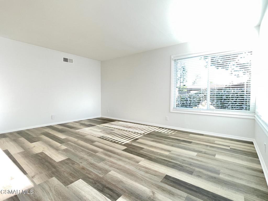 4881 Muirwood Court Simi Valley, CA 93063 - Photo 5 of 32 a view of a bedroom with wooden floor and a window