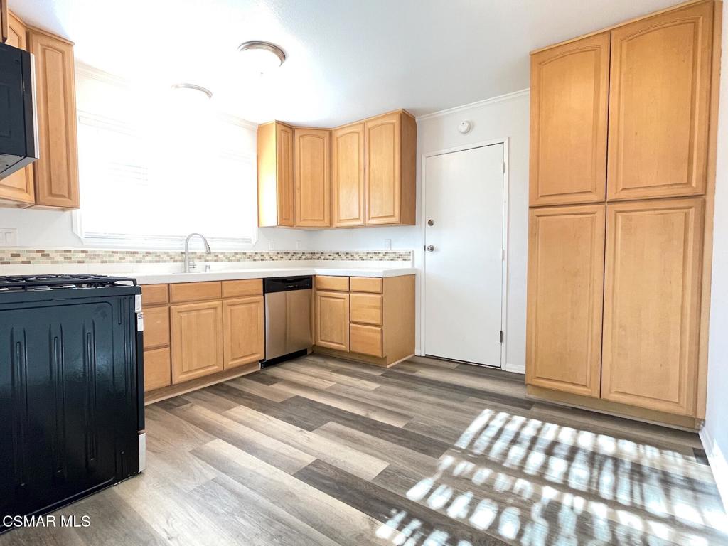 4881 Muirwood Court Simi Valley, CA 93063 - Photo 7 of 32 a view of a kitchen with granite countertop cabinets and sink