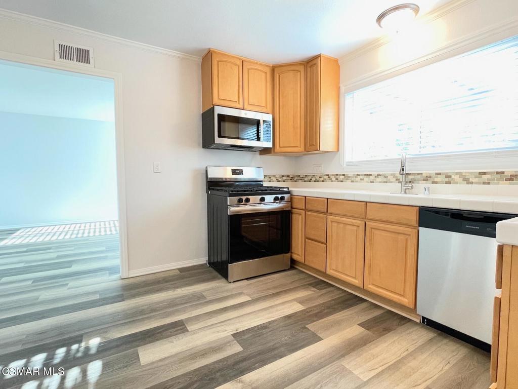 4881 Muirwood Court Simi Valley, CA 93063 - Photo 8 of 32 a kitchen with a sink stove and microwave
