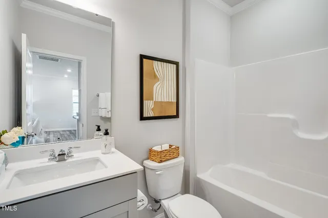 a bathroom with a sink toilet tub and vanity