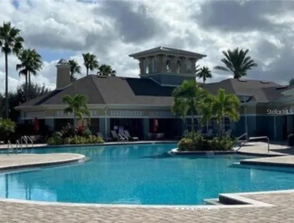 a front view of house with yard and lake view