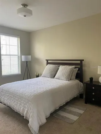 a bedroom with a bed and window