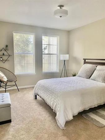 a bedroom with a bed and window