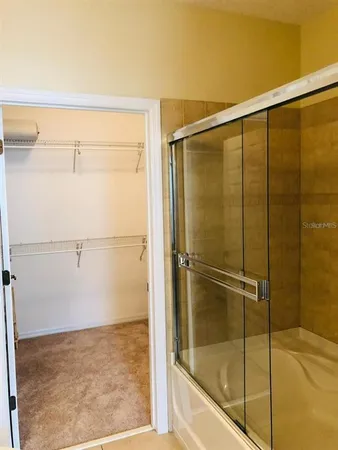 a bathroom with a glass shower door