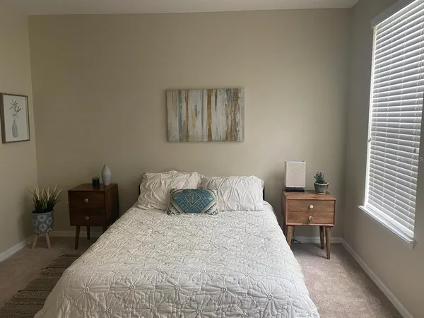 a bedroom with a bed and a window