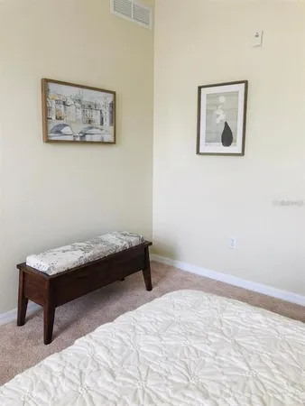 a bedroom with a bed and a desk