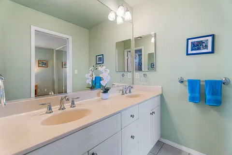 a bathroom with a double vanity sink and a mirror