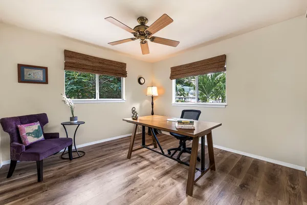 a view of a workspace with furniture window and wooden floor