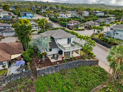 an aerial view of residential houses with outdoor space and river view