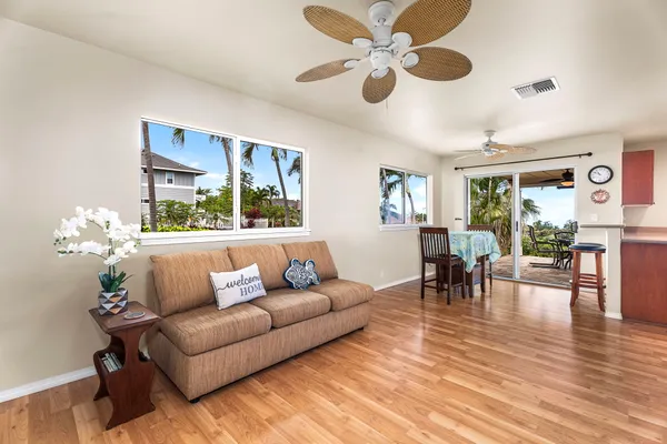 a living room with furniture and wooden floor