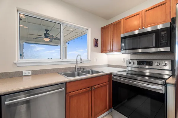 a kitchen with a sink stove and microwave