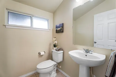 a bathroom with a sink a mirror and a toilet