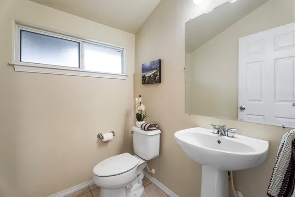 a bathroom with a sink a mirror and a toilet