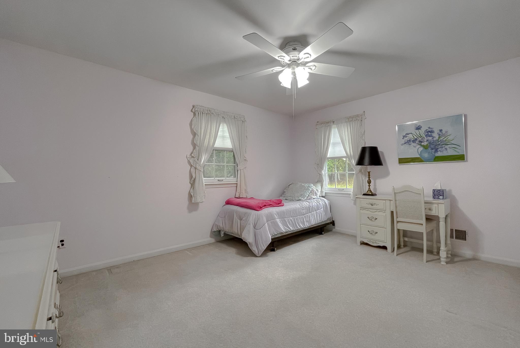 513 Clarks Run Road La Plata, MD 20646 - Photo 20 of 35 a spacious bedroom with a bed and a chandelier