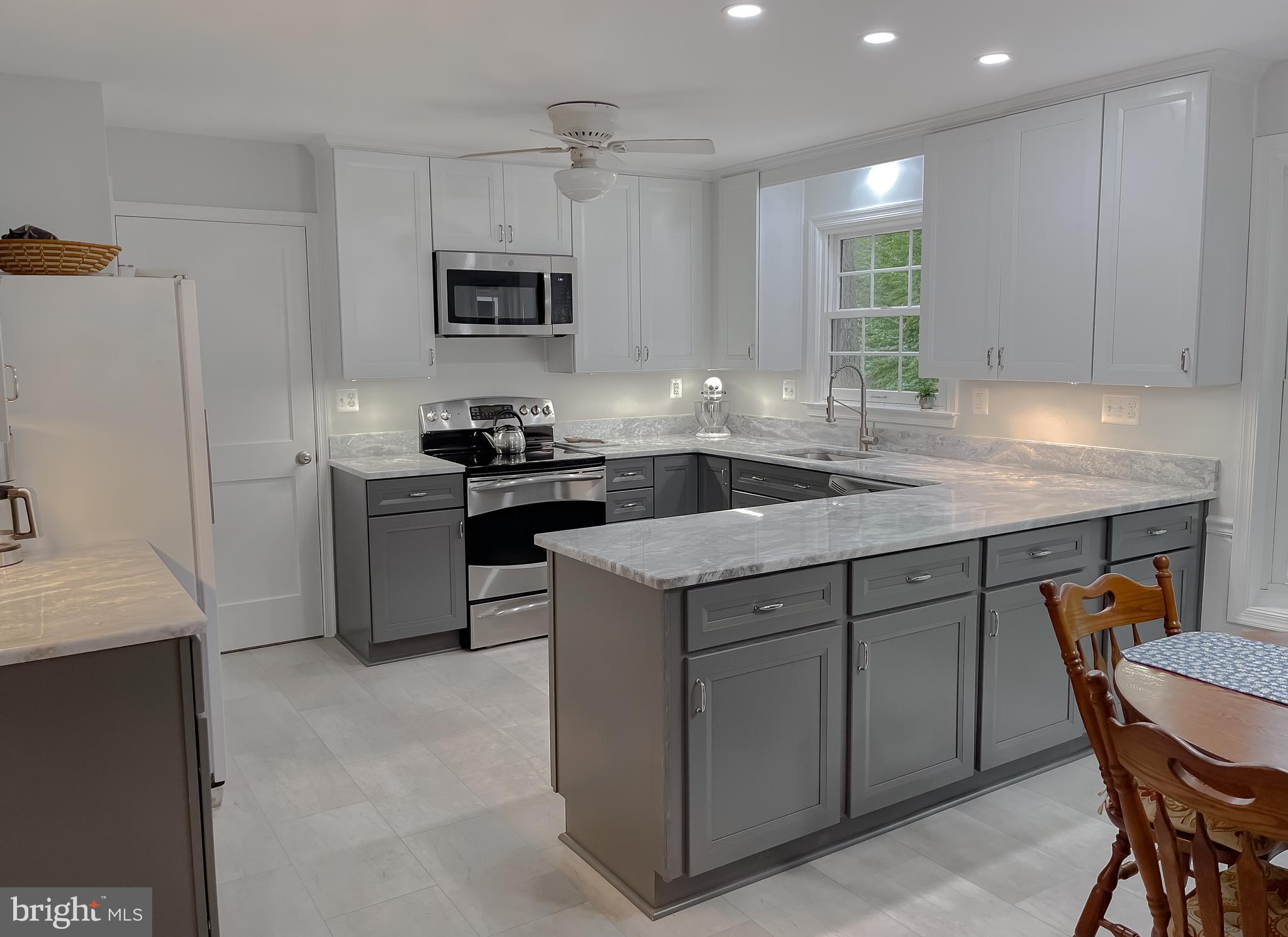 513 Clarks Run Road La Plata, MD 20646 - Photo 8 of 35 a kitchen with a stove a sink a microwave a counter space and cabinets