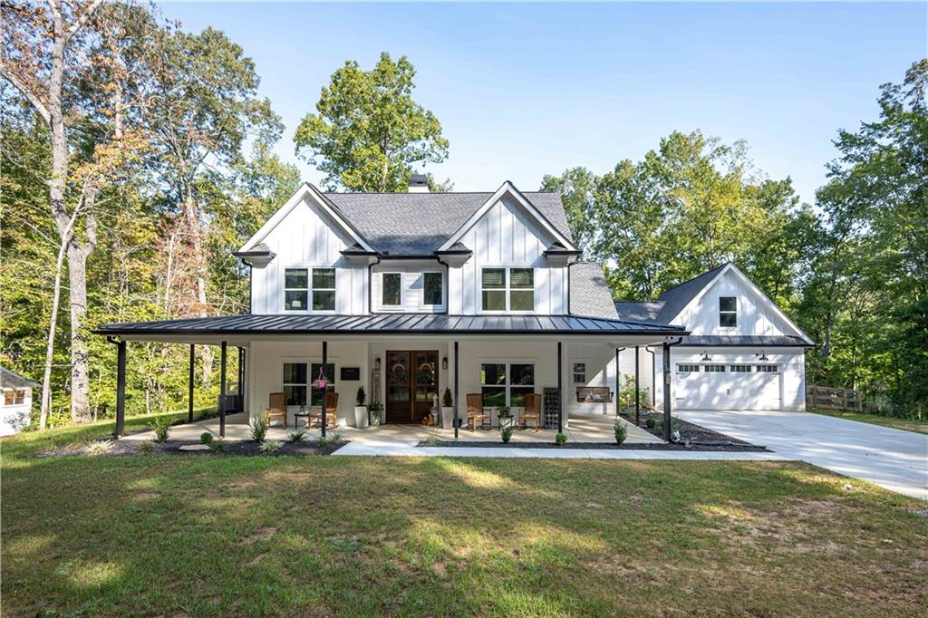1744 Monroe Mill Road Buchanan, GA 30113 - Photo 1 of 1 a front view of a house with swimming pool having outdoor seating