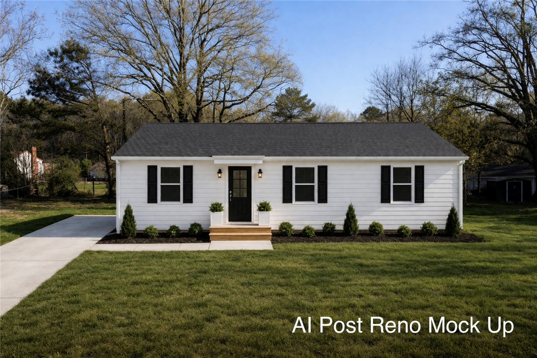 1307 East Park Drive Anderson, SC 29621 - Photo 12 of 12 A charming white ranch home features a welcoming dark door and manicured landscaping.