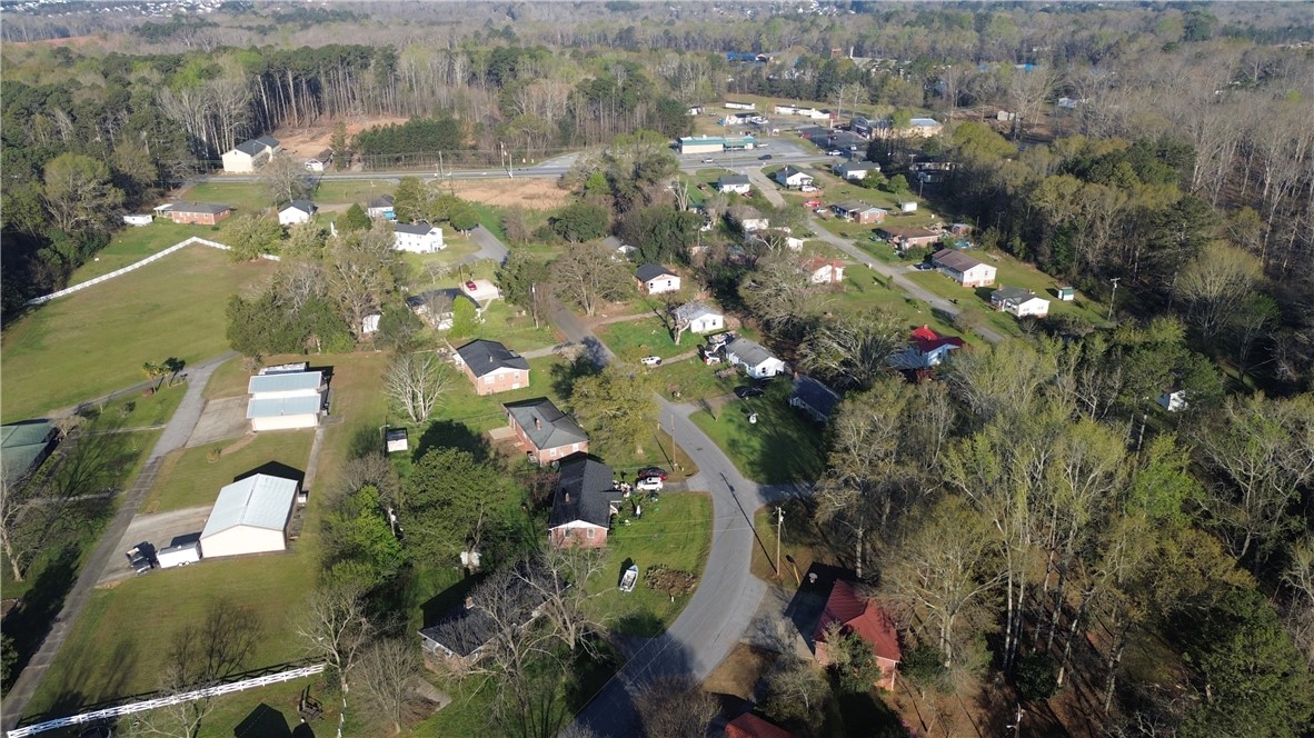 1307 East Park Drive Anderson, SC 29621 - Photo 6 of 12 An aerial perspective reveals a vibrant neighborhood nestled among lush, green trees and a winding road.