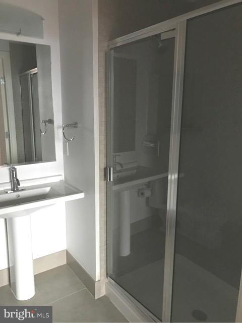 2125 14th Street Northwest, Unit 527 Washington, DC 20009 - Photo 14 of 20 a bathroom with a shower and a sink