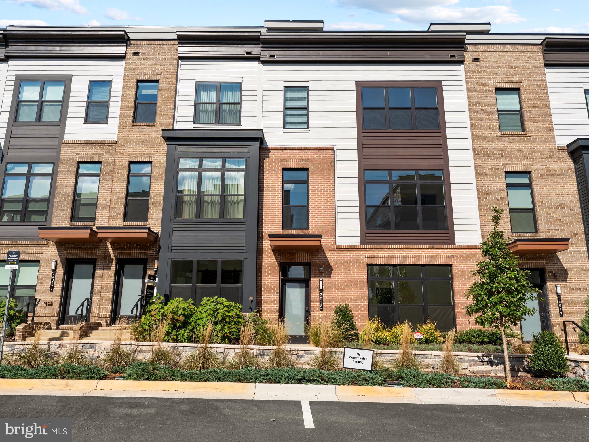 a front view of a residential apartment building with a yard