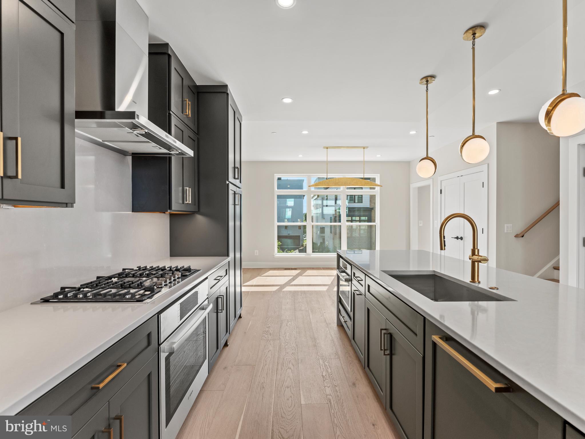 2015 Tysons Ridgeline Road Falls Church, VA 22043 - Photo 11 of 33 a kitchen with stainless steel appliances a sink stove and cabinets