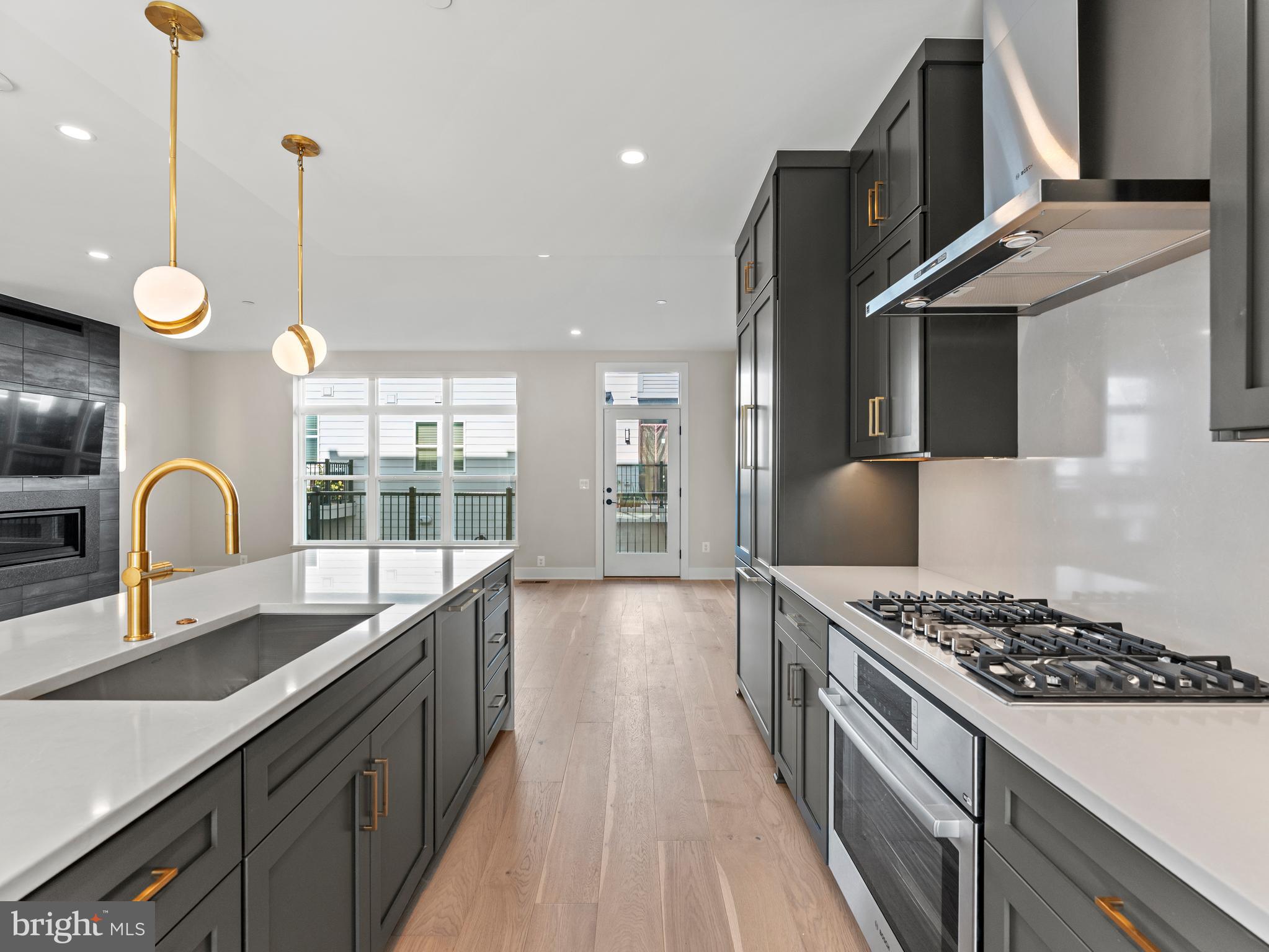 2015 Tysons Ridgeline Road Falls Church, VA 22043 - Photo 13 of 33 a kitchen with kitchen island granite countertop a stove and a sink