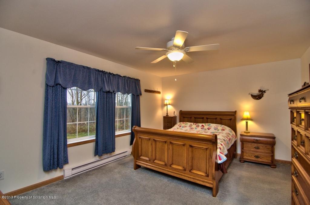1633 Howe Road Moscow, PA 18444 - Photo 15 of 59 a bedroom with a bed and a window