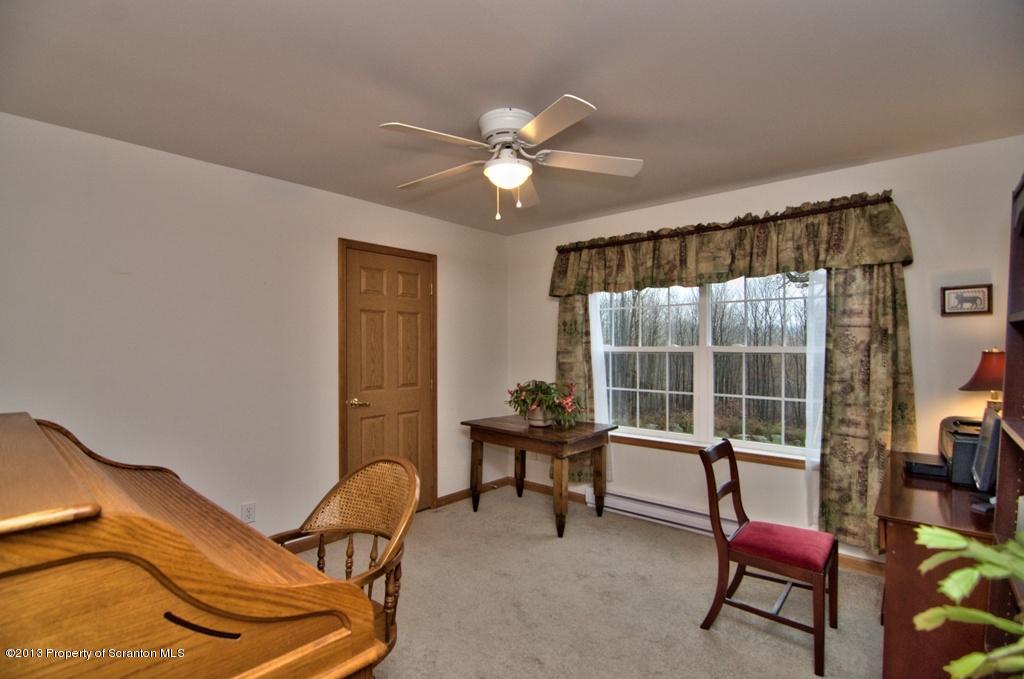 1633 Howe Road Moscow, PA 18444 - Photo 20 of 59 a living room with furniture and floor to ceiling window