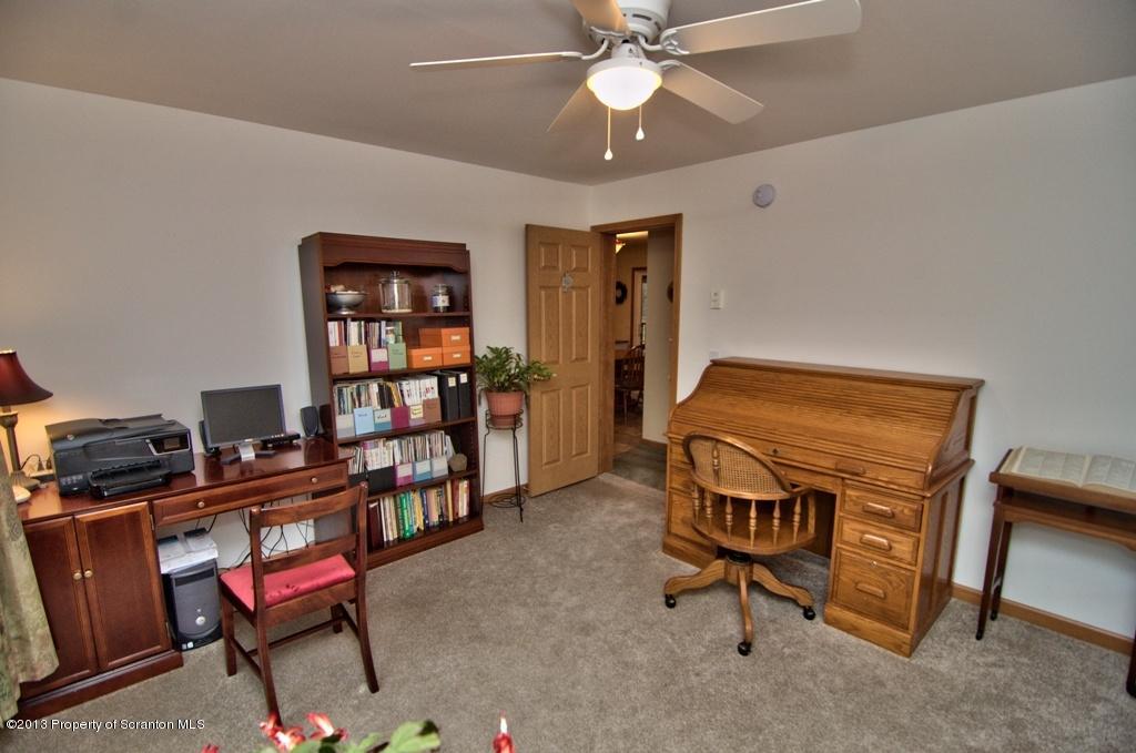 1633 Howe Road Moscow, PA 18444 - Photo 23 of 59 a view of a workspace with furniture and a bookshelf