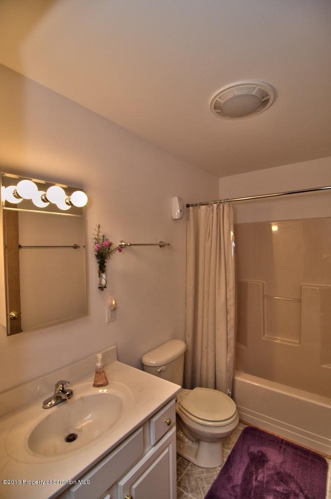 1633 Howe Road Moscow, PA 18444 - Photo 44 of 59 a bathroom with a sink toilet a mirror and shower