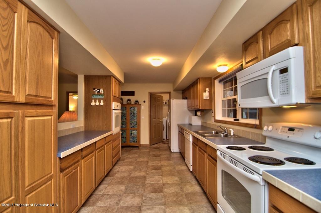 1633 Howe Road Moscow, PA 18444 - Photo 47 of 59 a kitchen with stainless steel appliances granite countertop a stove and a refrigerator