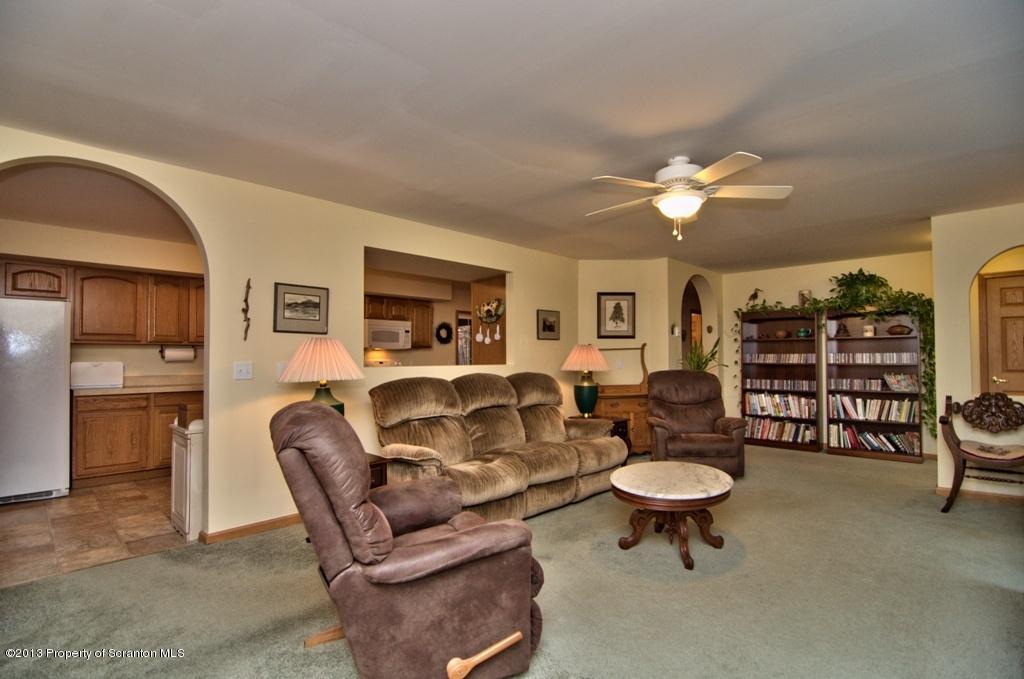 1633 Howe Road Moscow, PA 18444 - Photo 57 of 59 a living room with furniture a fireplace and a flat screen tv
